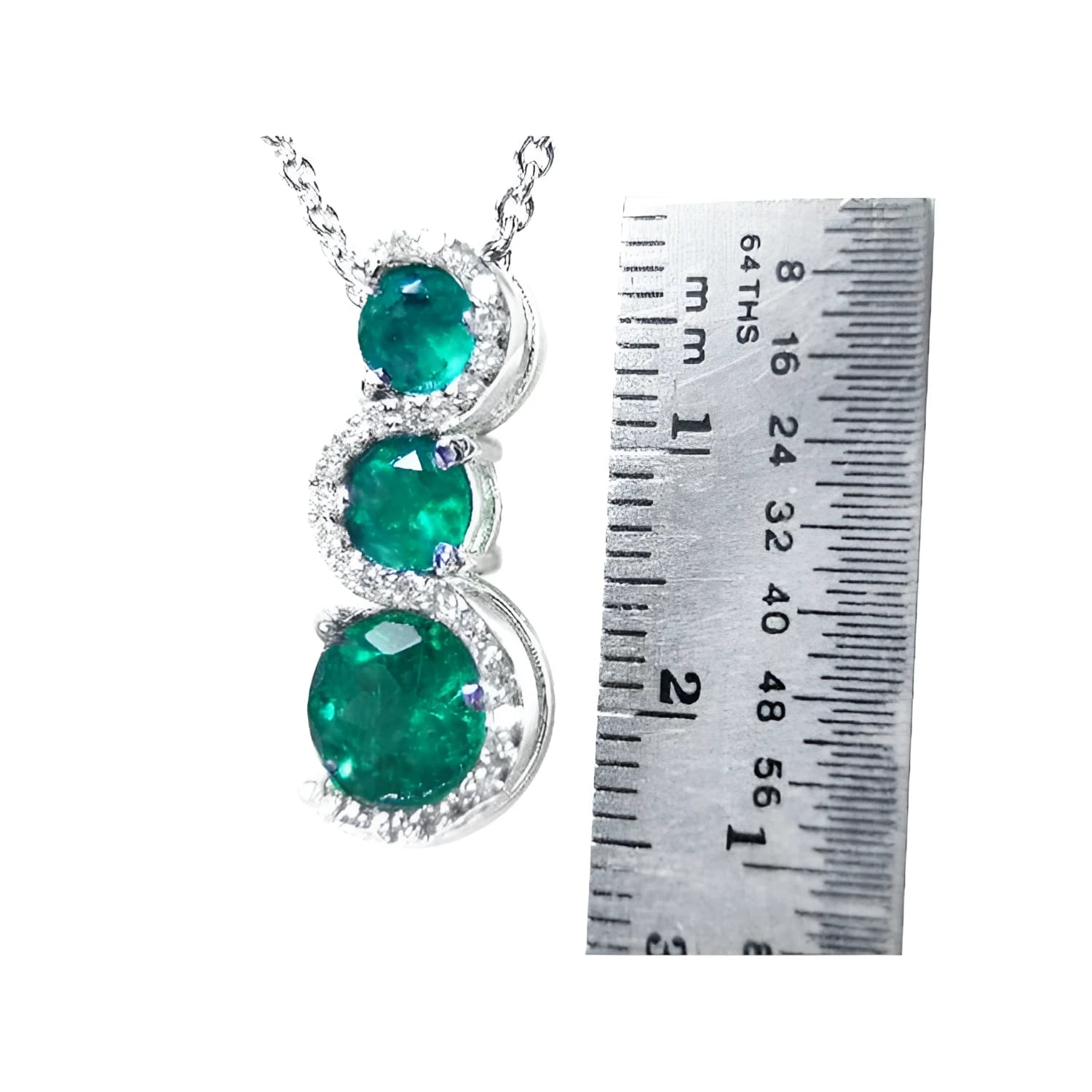 14K white gold emerald journey pendant with three round Colombian emeralds and diamonds on a twisted path.