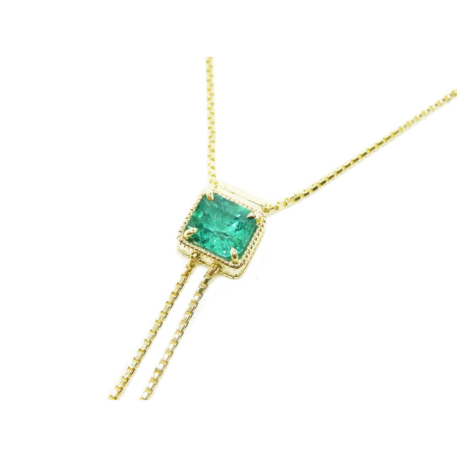 14K gold lariat necklace with a square emerald-cut natural Muzo emerald, milgrain, and prongs.