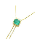 14K gold lariat necklace with a square emerald-cut natural Muzo emerald, milgrain, and prongs.