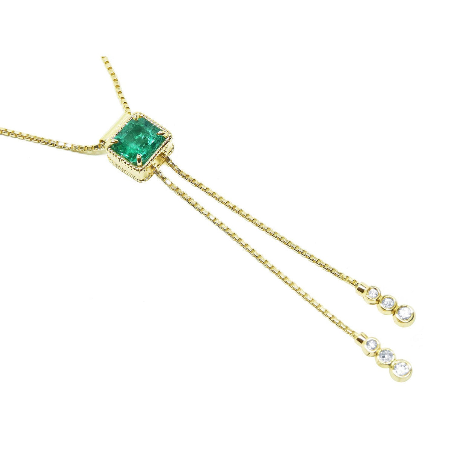 14K gold lariat necklace with a square emerald pendant and dangling diamond accents on a box chain.