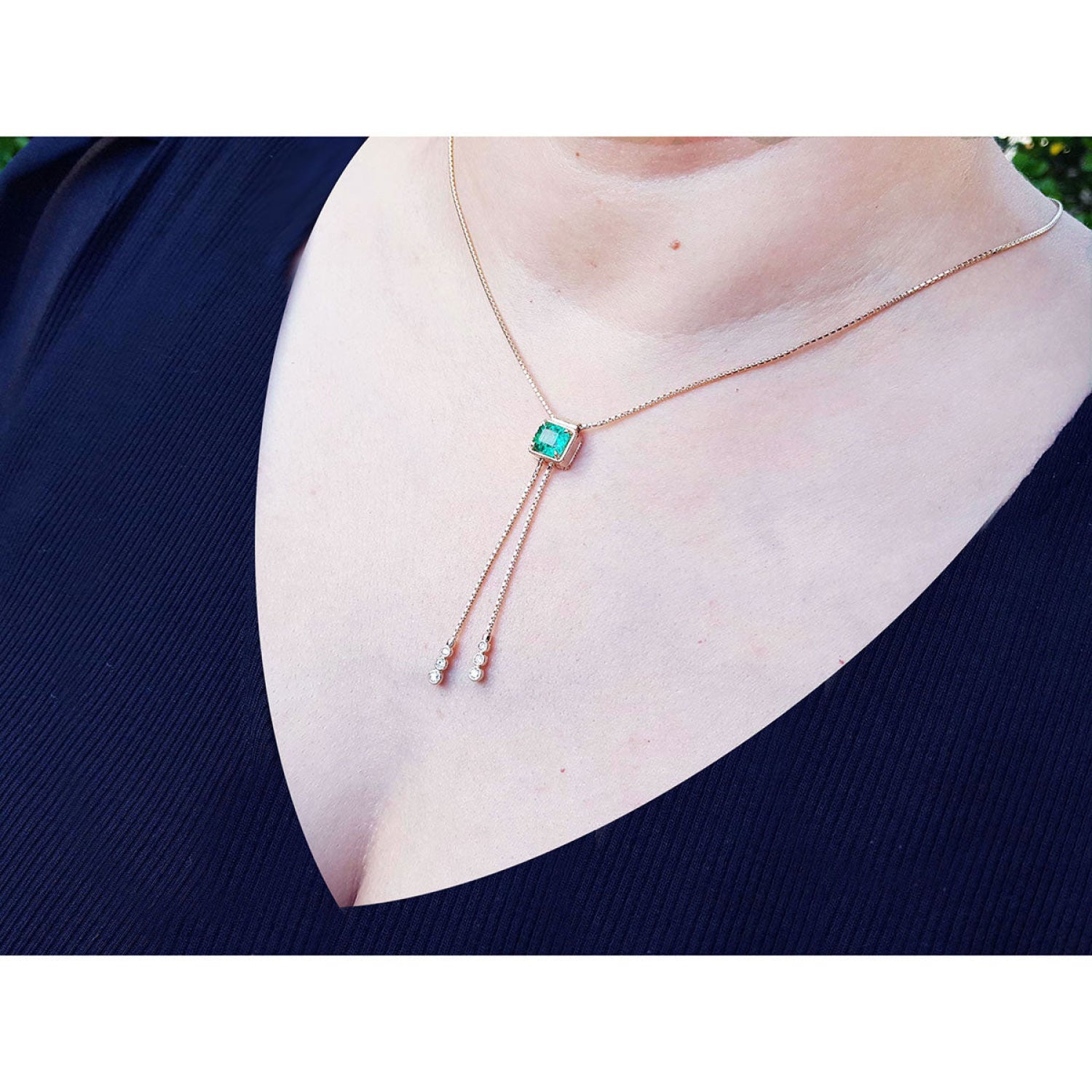 Emerald lariat necklace with 1.48 ct natural Muzo Colombia emerald, 14K gold box chain, and dangling accents.