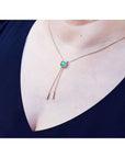 Emerald lariat necklace with 1.48 ct natural Muzo Colombia emerald, 14K gold box chain, and dangling accents.