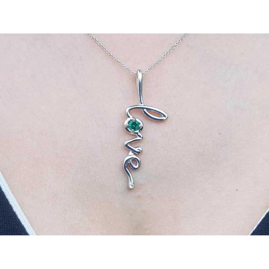 14K white gold "Love" script pendant necklace with a round cut Colombian emerald.