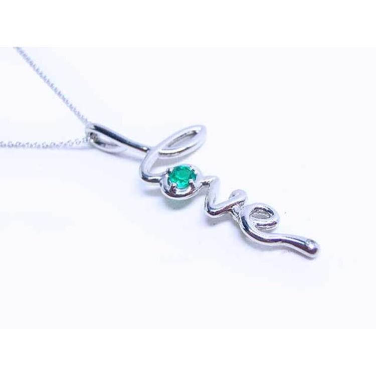 A white gold necklace with a script love pendant featuring an emerald stone on a white background.