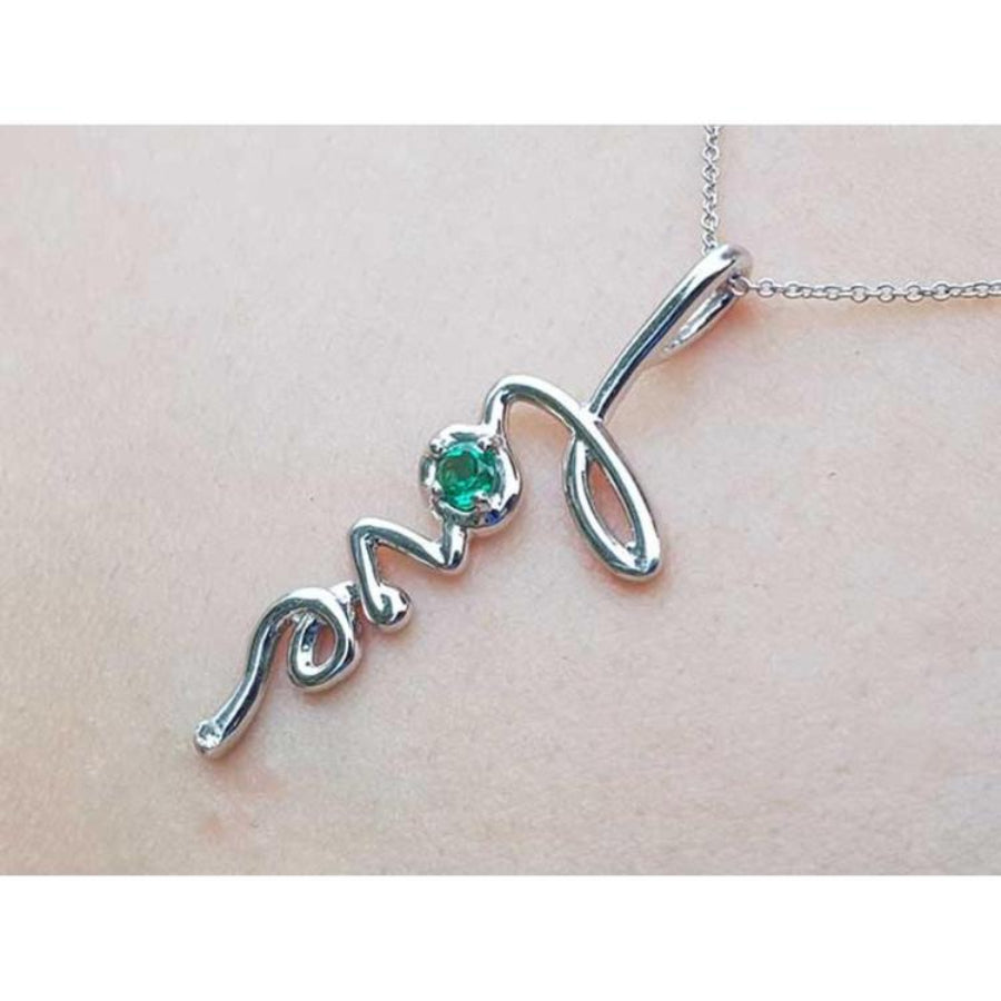 14K white gold "love" script pendant with a round Colombian emerald, on a delicate chain.