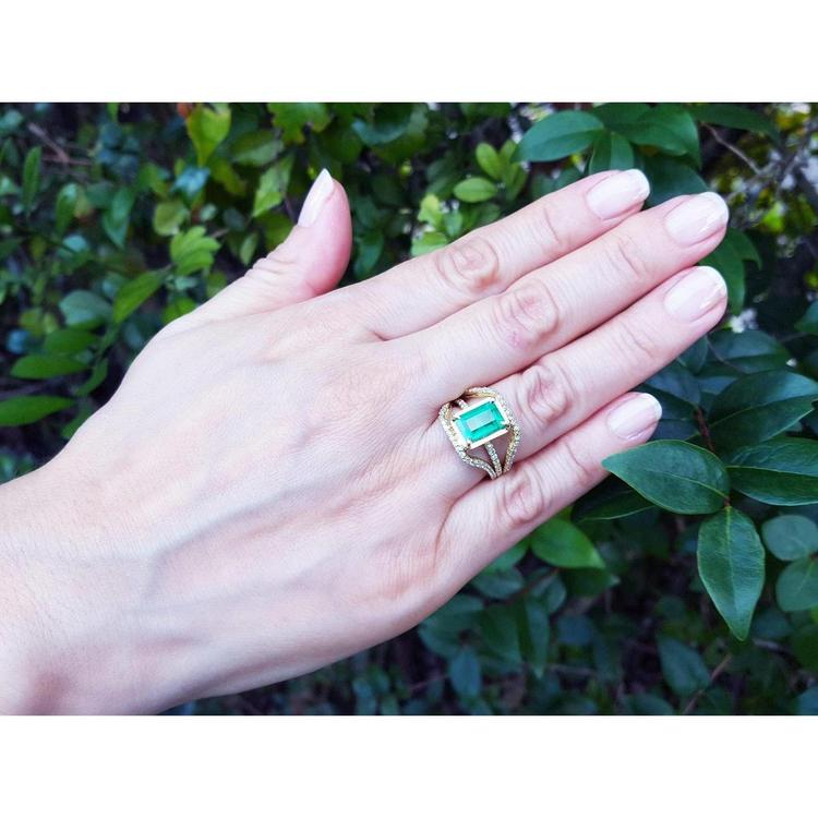 Emerald engagement ring, 2.86 ct. medium green emerald, 18K yellow gold, three rows of diamonds.
