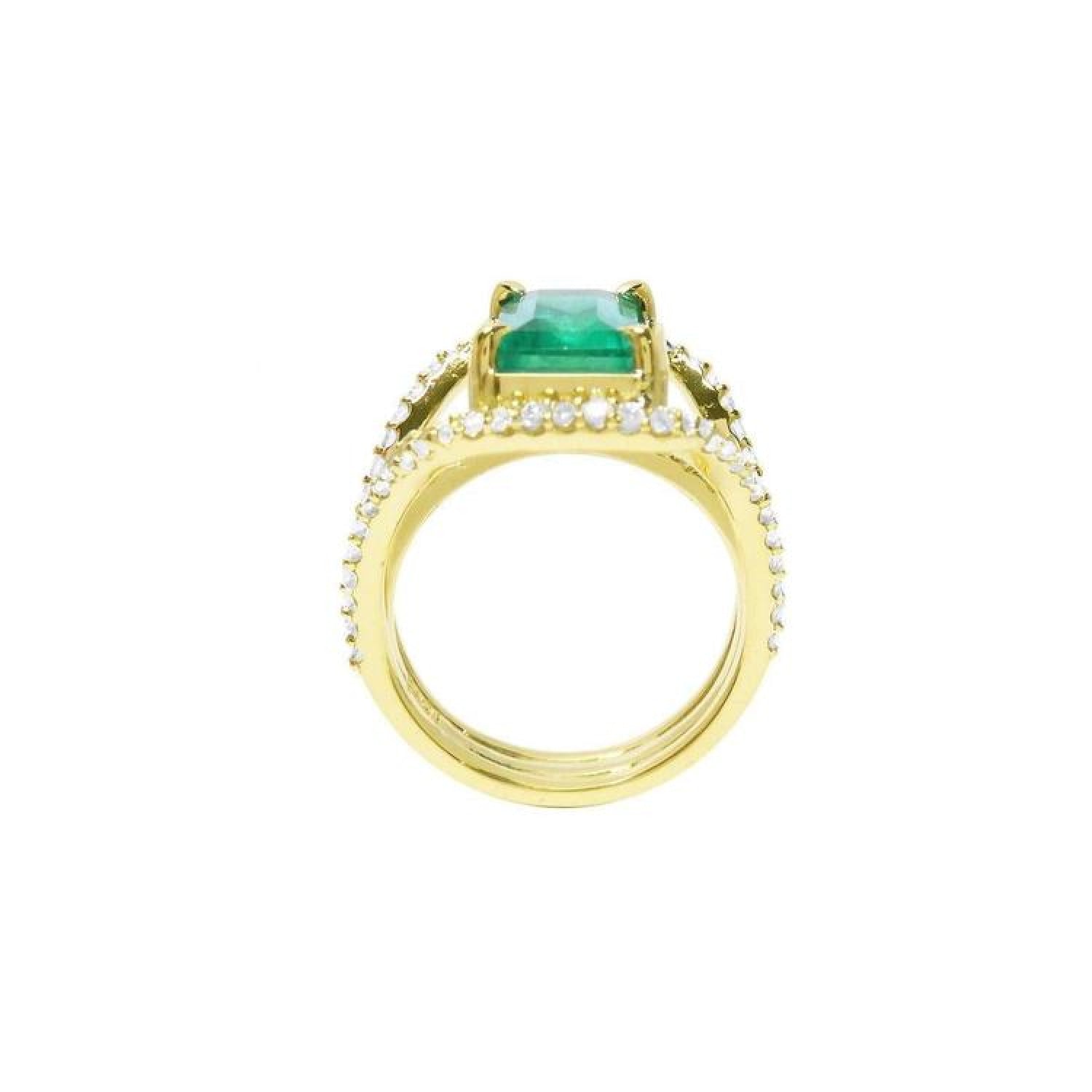 18K yellow gold engagement ring with a 2.86 ct emerald and three rows of diamonds.