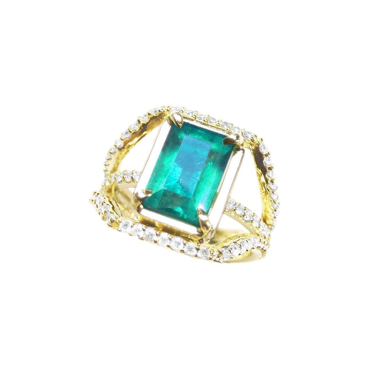 Gold ring emerald and diamond May birthstone on a white background.
