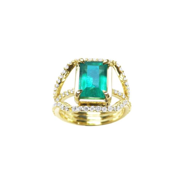 Emerald engagement ring in 18K yellow gold with a rectangular green emerald and three rows of diamonds.