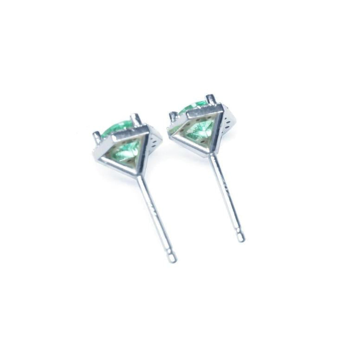 Pair of round cut emerald stud earrings in 14K white gold with push back closures.
