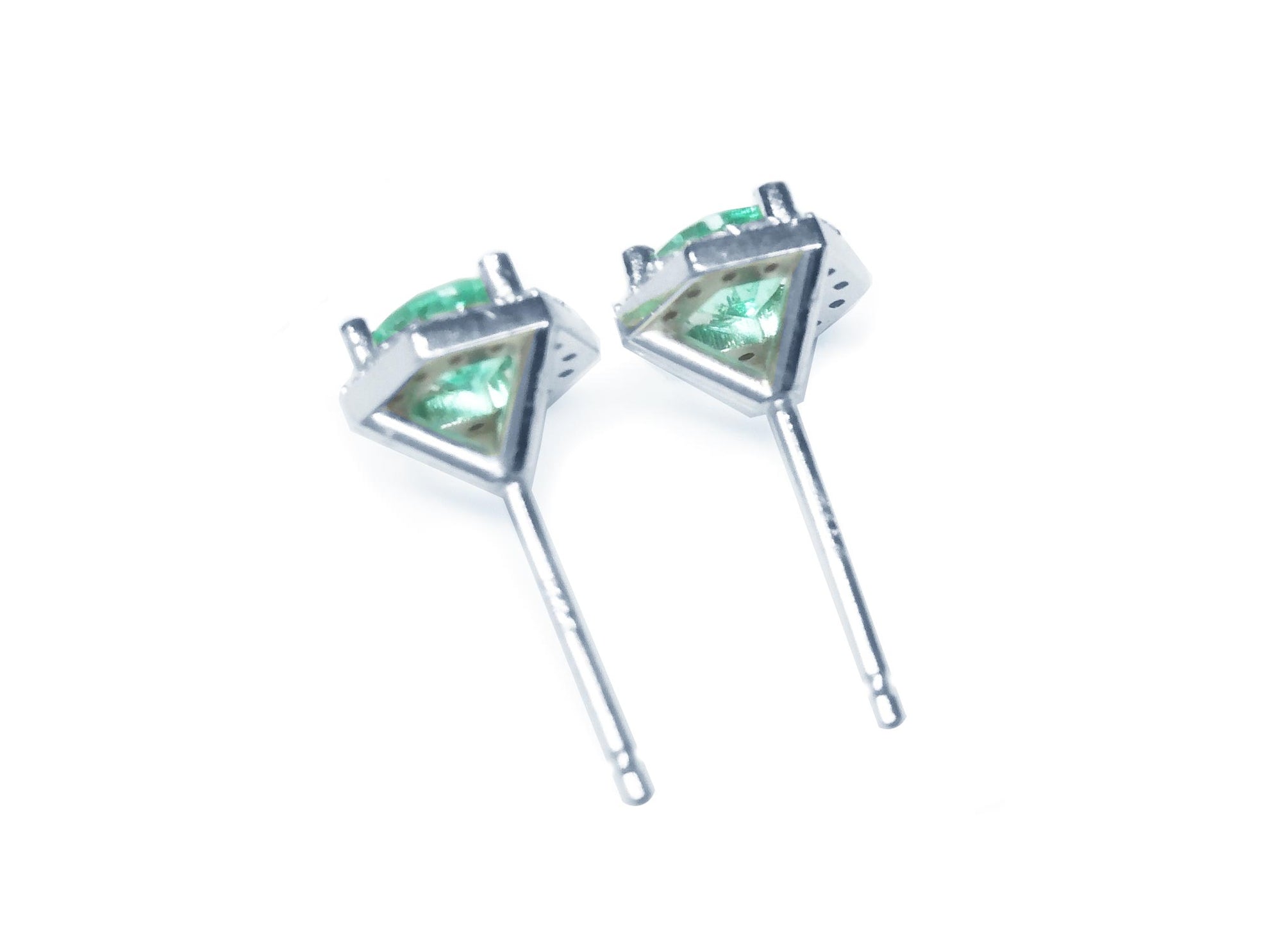 Pair of 14k white gold May birthstone emerald stud earrings, underside view.