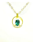 14k yellow gold necklace with oval Colombian emerald pendant and diamond accents.