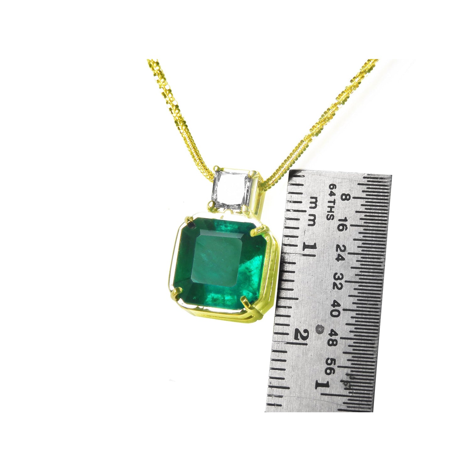 18K yellow gold necklace with a large asscher cut Colombian emerald and a princess cut diamond.