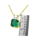 18K yellow gold necklace with a large asscher cut Colombian emerald and a princess cut diamond.