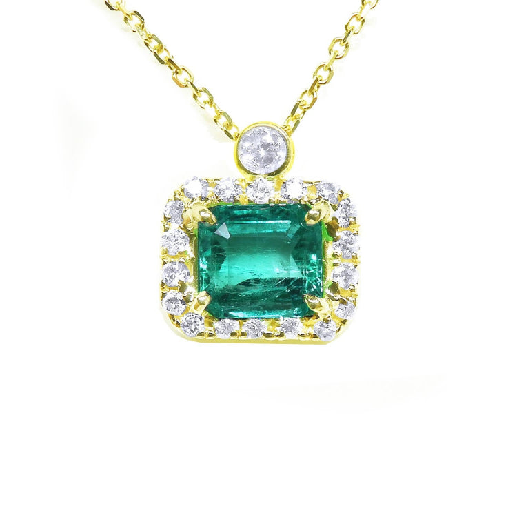 Colombian emerald necklace east west orientation encircled in a halo of natural diamonds, crafted in 14k yellow gold