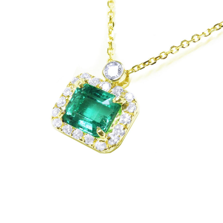 Natural emerald necklace east west orientation encircled in a halo of natural diamonds, crafted in 14k yellow gold