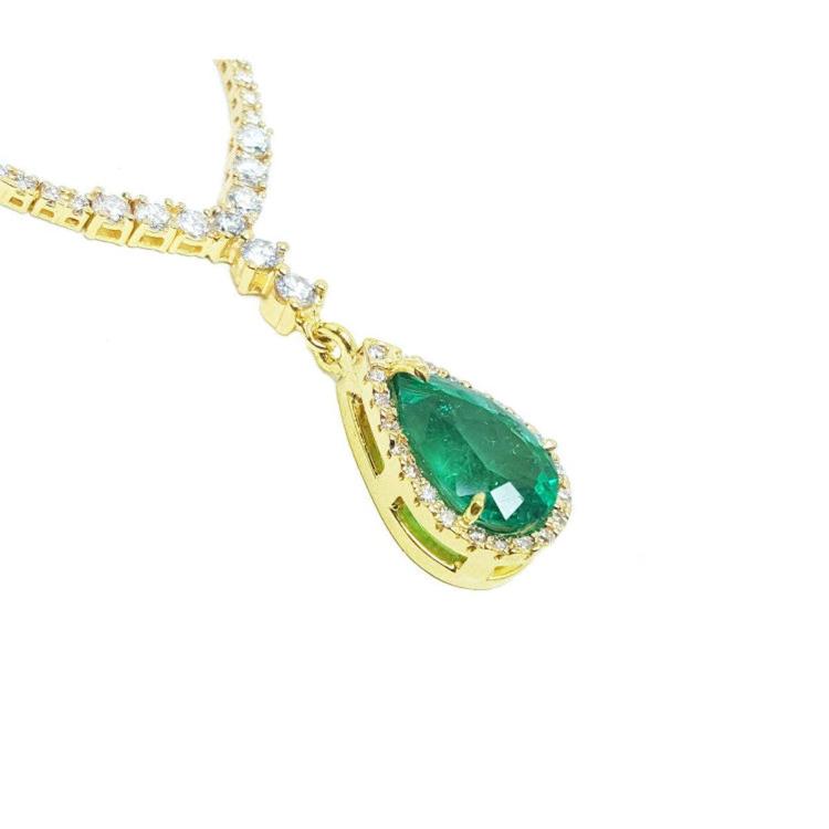 18k yellow gold necklace with a natural emerald teardrop pendant halo diamond.