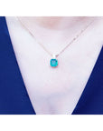 Asscher cut Colombian emerald necklace with a princess cut diamond on an 18K yellow gold chain.