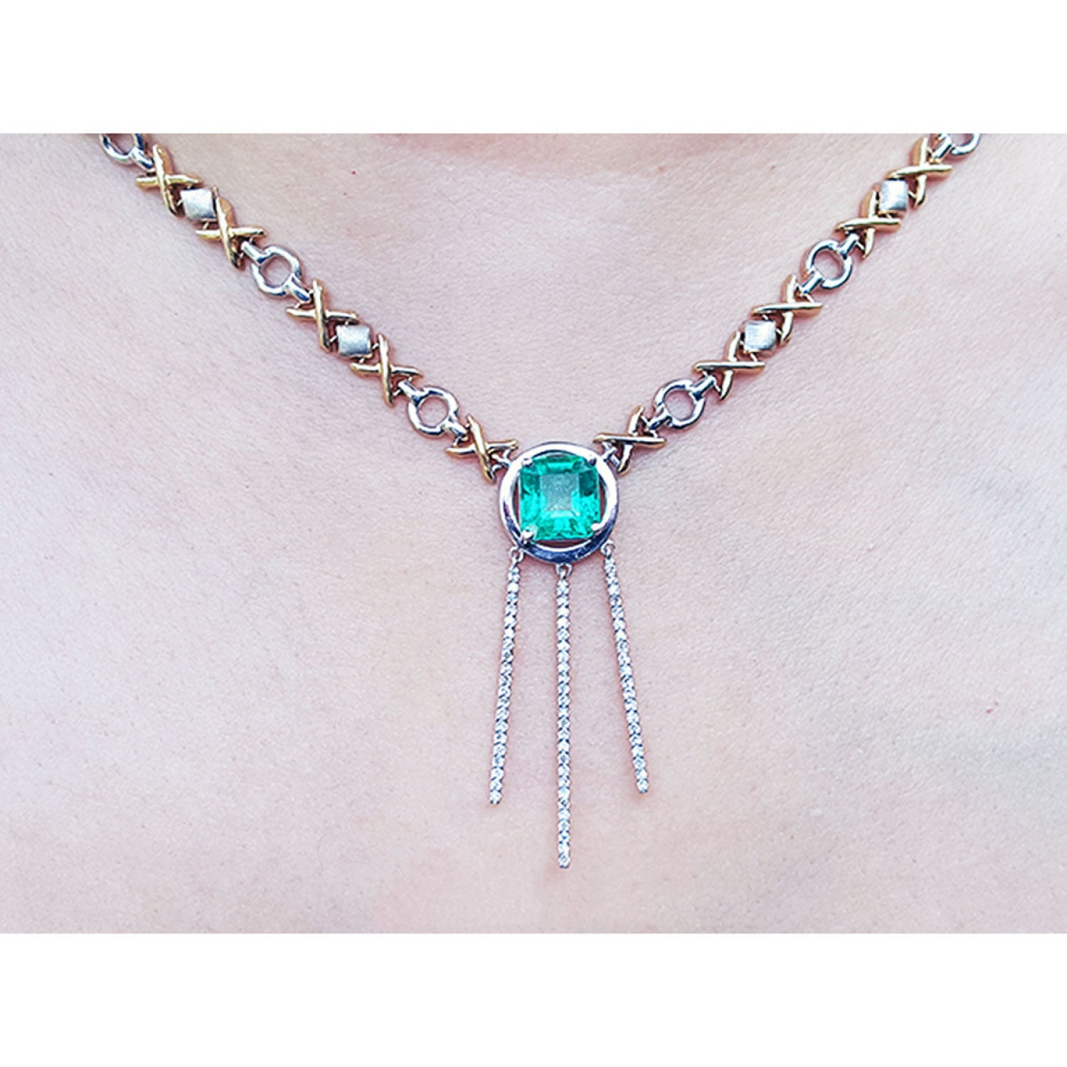 14K white and yellow gold Kisses and Hugs necklace with a square emerald pendant and diamond dangles.
