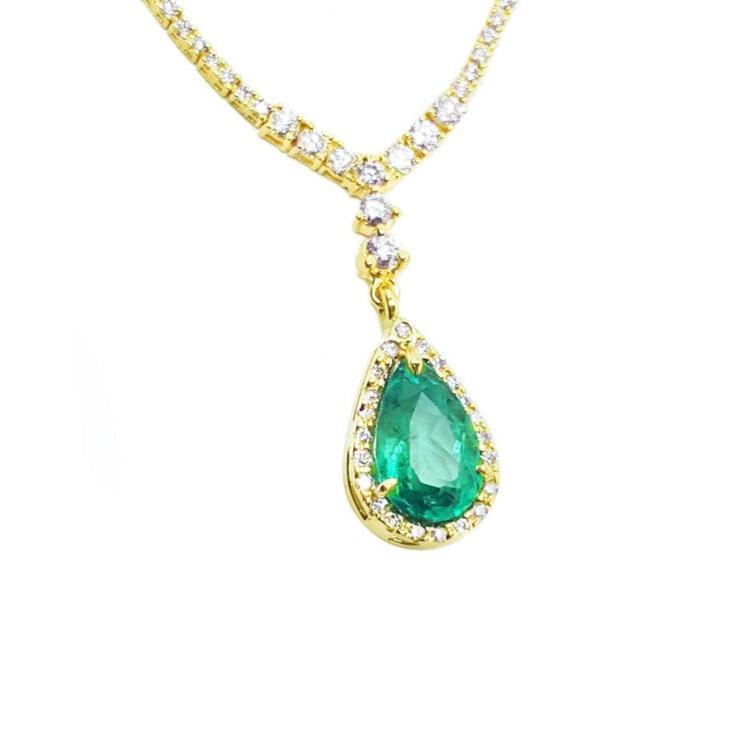 18k gold necklace with a colombian natural emerald teardrop pendant and halo diamonds.