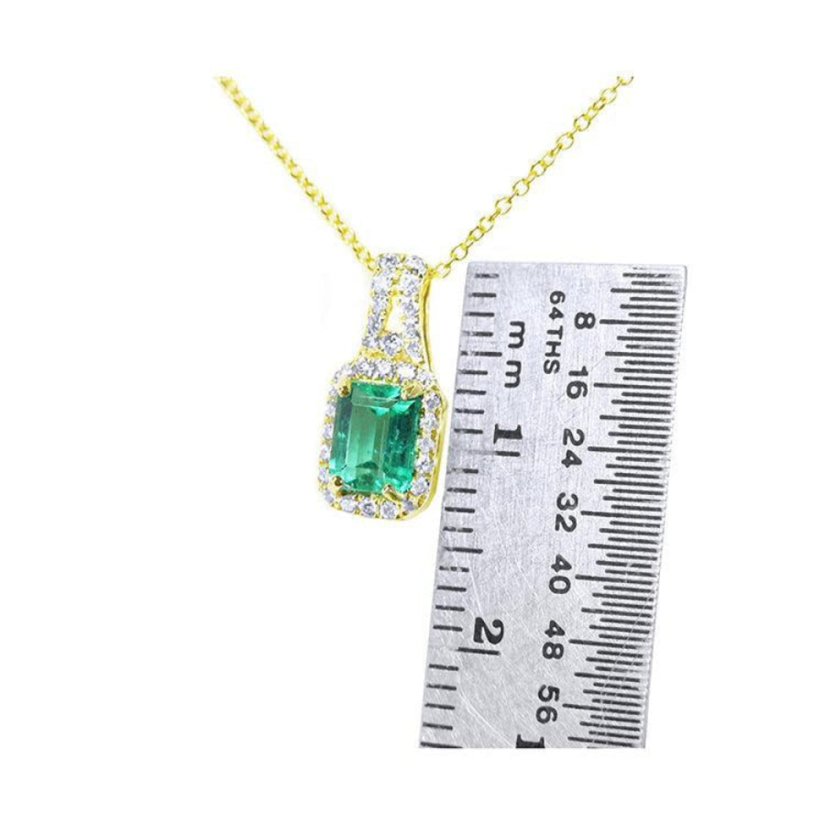 14K gold emerald cut Colombian emerald necklace with halo diamonds, shown next to a ruler.