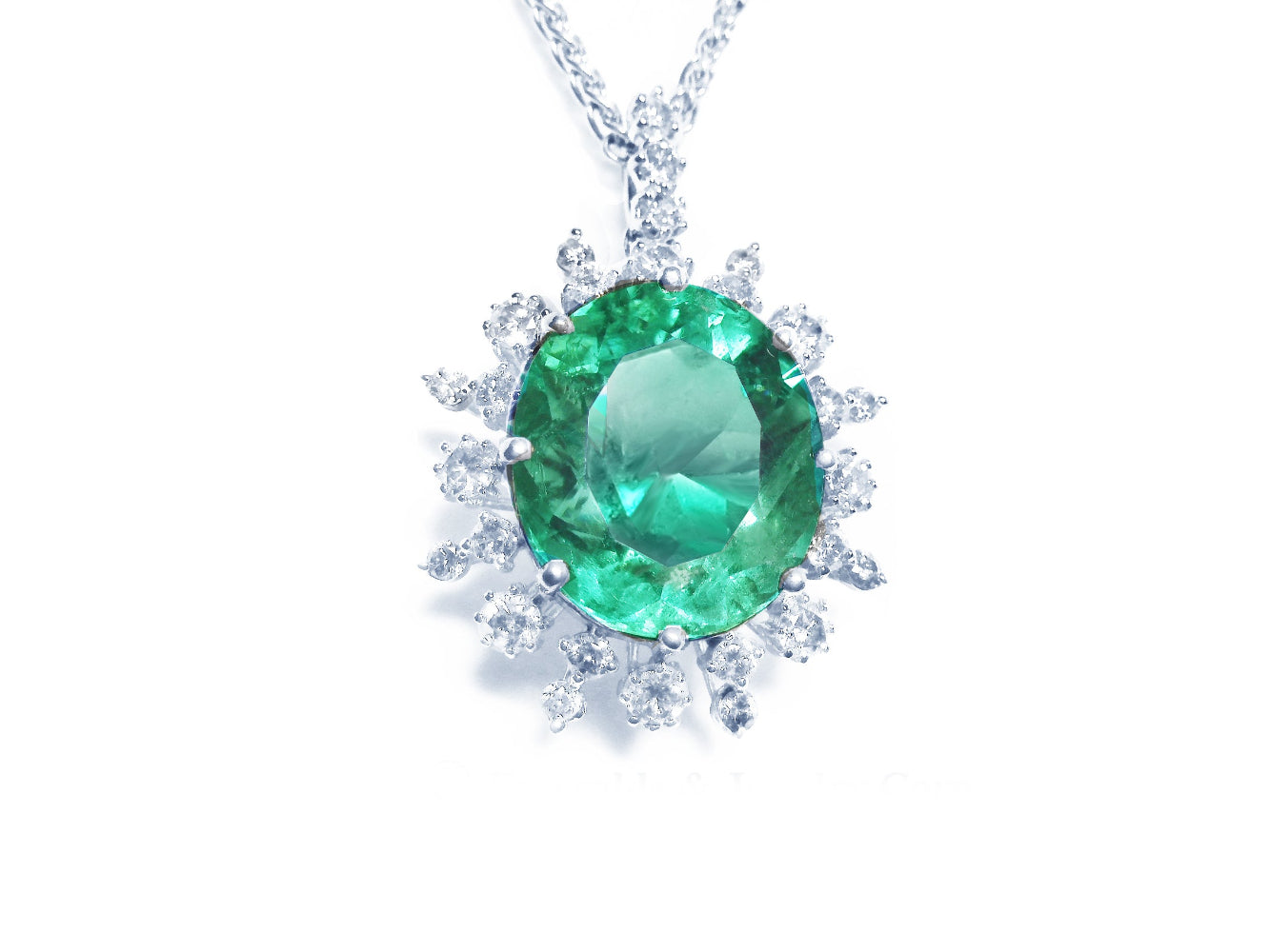Emerald gemstone pendant with diamond accents showing top topside on a white background