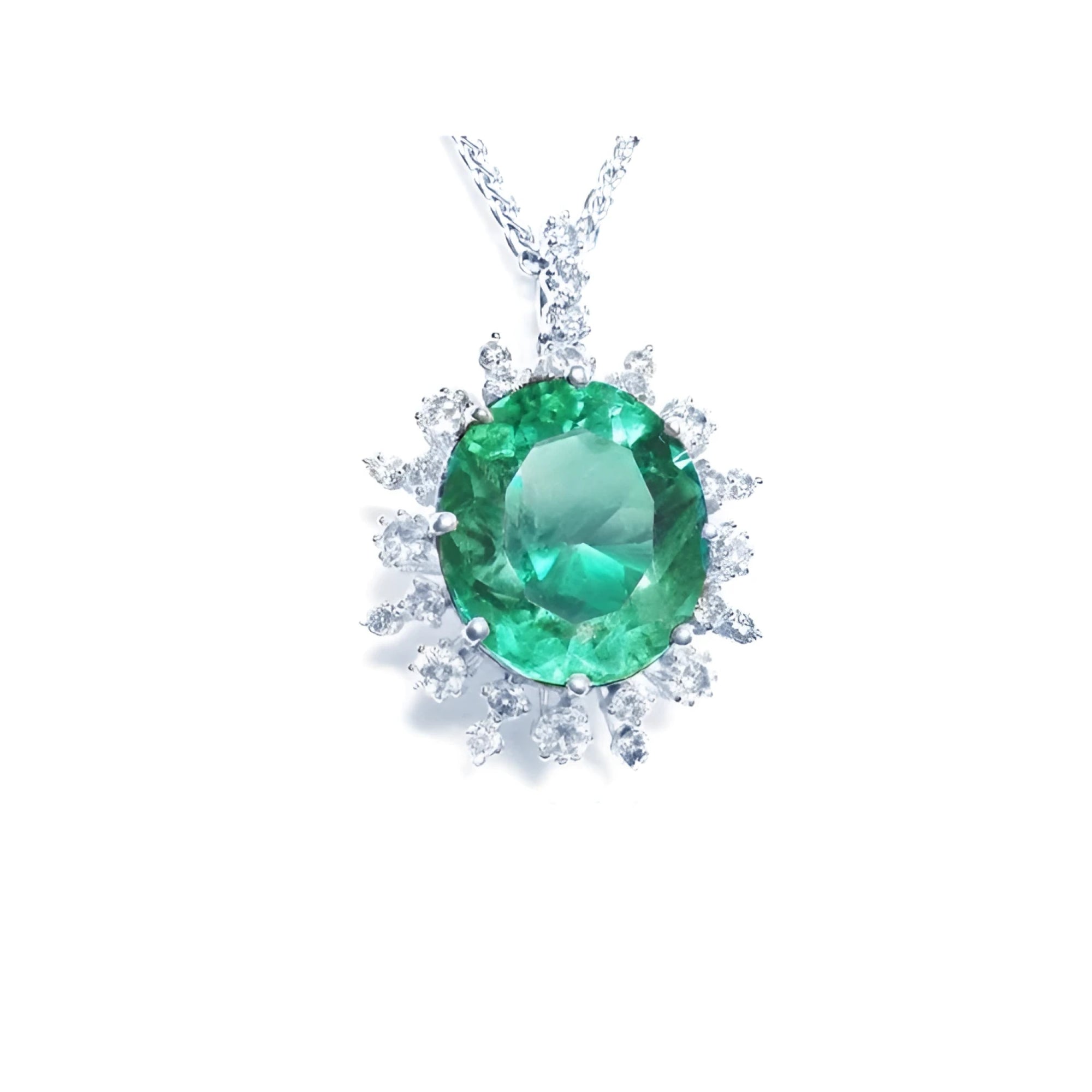 Oval cut medium light green emerald pendant with diamond halo in 14K white gold.