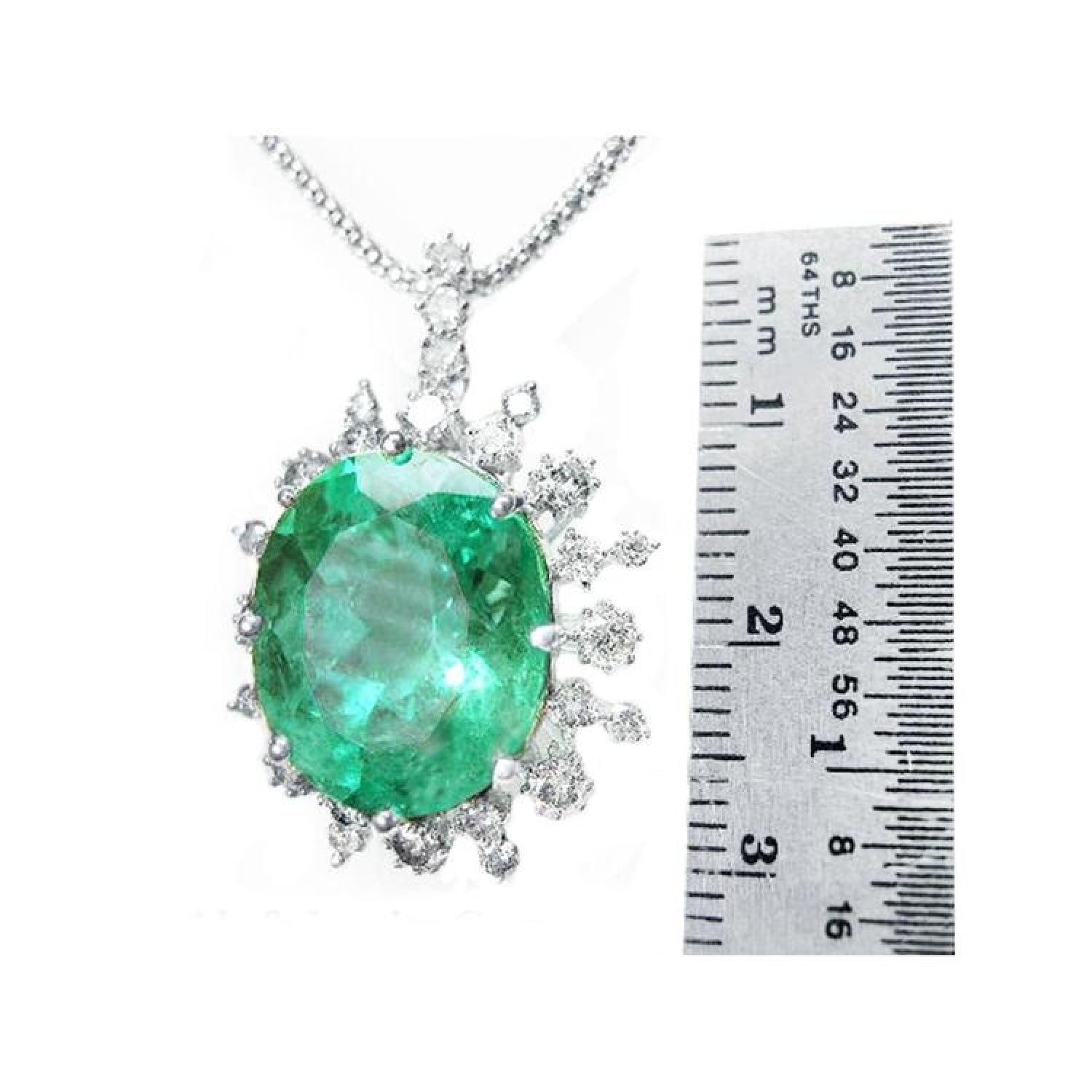 10.91 ct. oval emerald pendant with diamond halo in 14K white gold, shown next to a ruler.