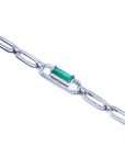 White gold paperclip bracelet with a colombian emerald and diamonds on a lateral view profile.