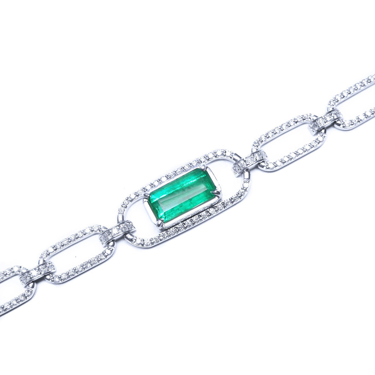 The topside view of a paperclip style bracelet with a natural colombian emerald on a white background