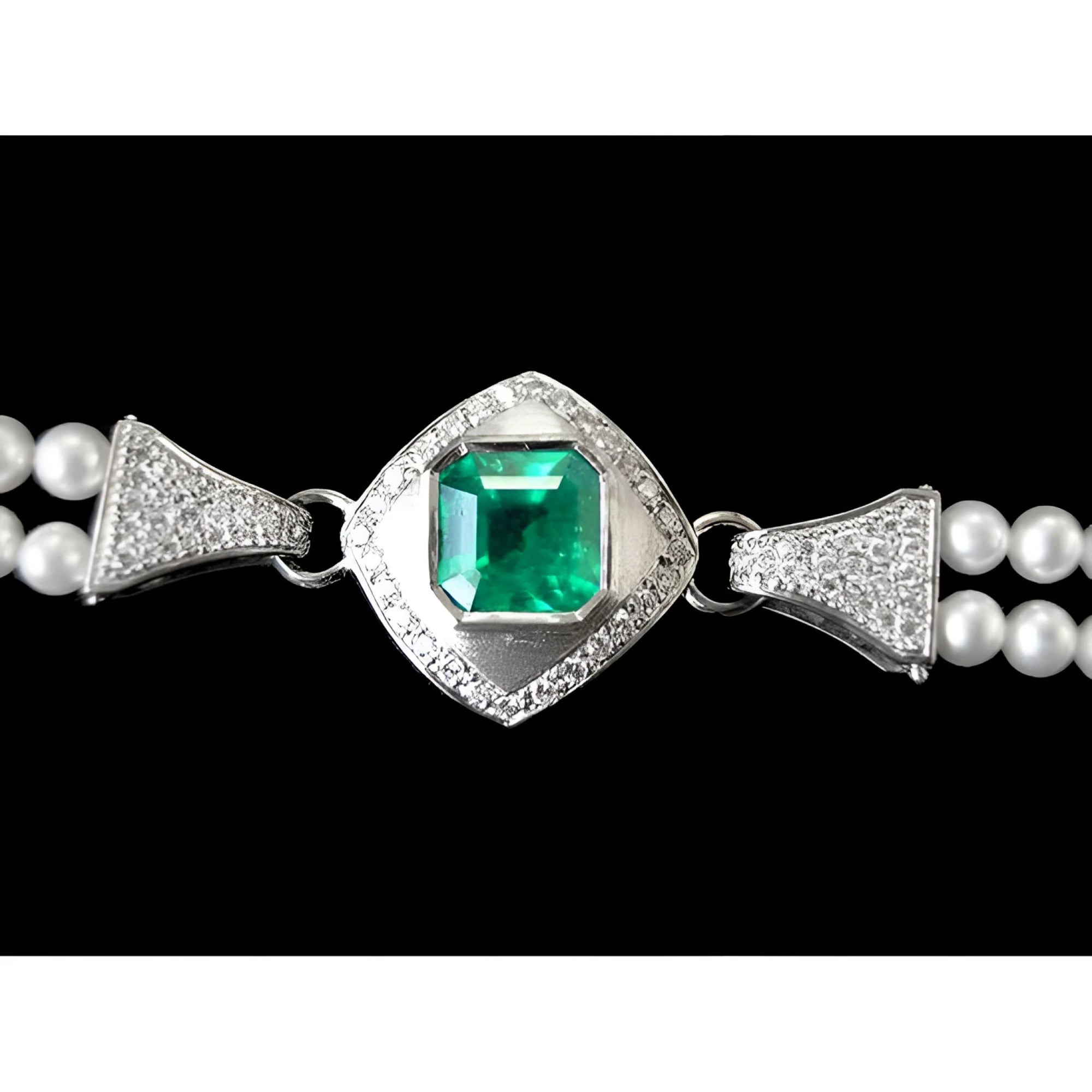 18K white gold emerald and pearl bracelet with diamond accents and a bezel-set Colombian emerald clasp.