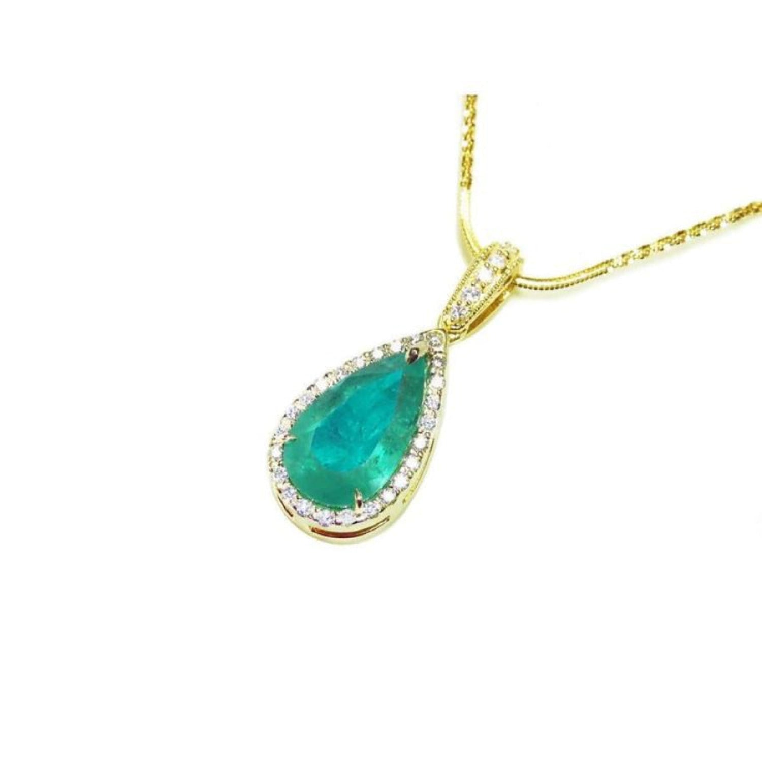 18K yellow gold teardrop emerald pendant with halo diamonds on a delicate chain.