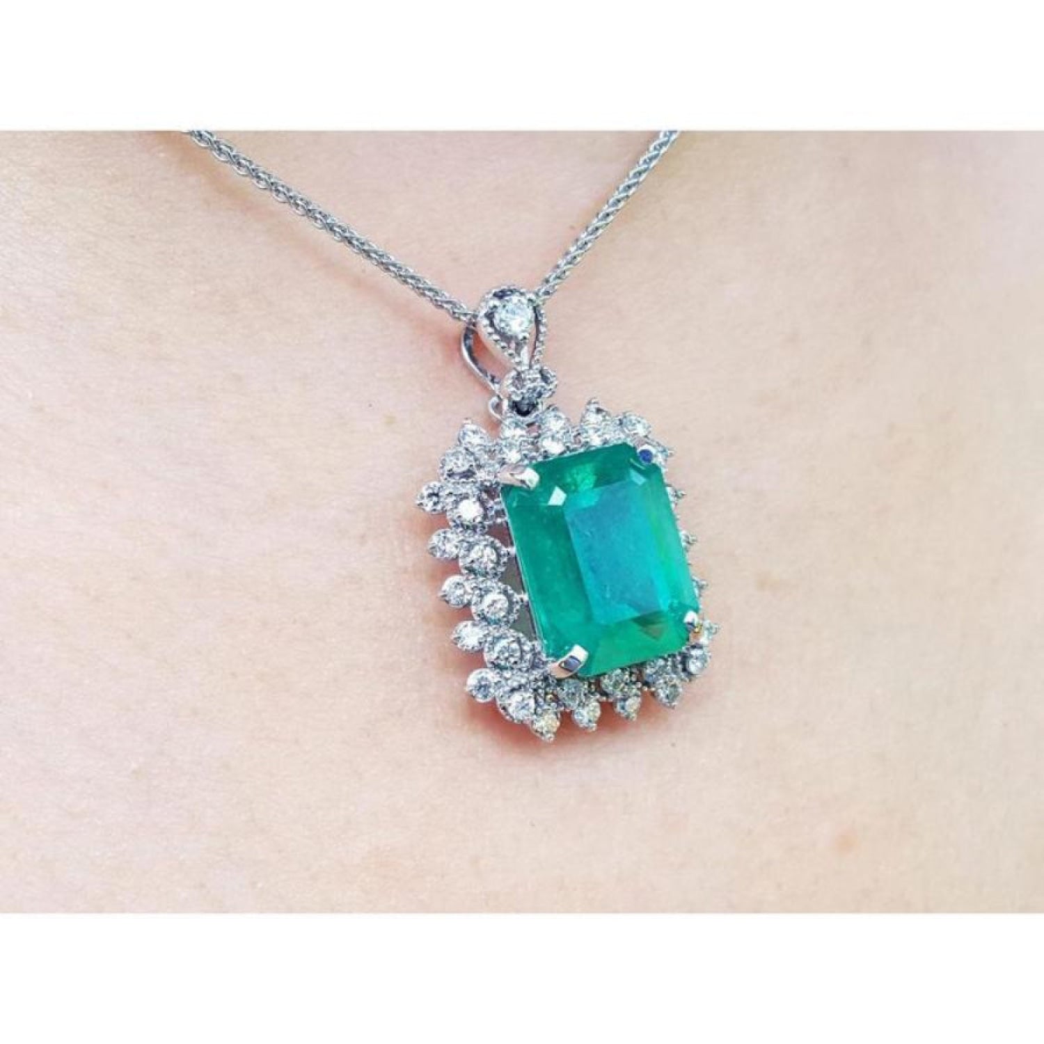 7.78 ct. natural emerald pendant with deep green rectangular stone, double halo diamonds, 14K white gold, antique style.