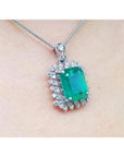 7.78 ct. natural emerald pendant with deep green rectangular stone, double halo diamonds, 14K white gold, antique style.