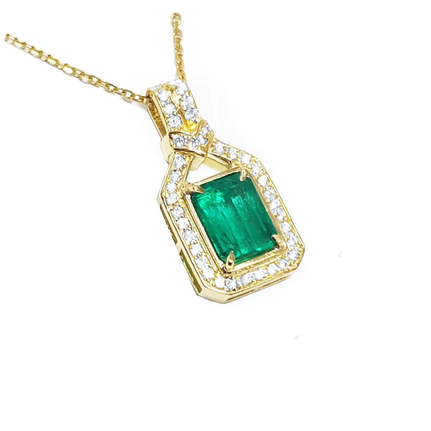 A 18k yellow gold emerald pendant with natural accent diamonds surrounding the square gemstone.