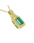 18K yellow gold emerald pendant with natural diamonds, rectangular emerald, and diamond-studded bail.
