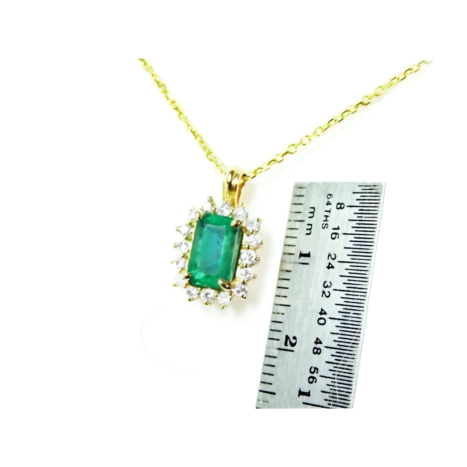 14K yellow gold emerald pendant with natural halo diamonds, shown next to a ruler for scale.