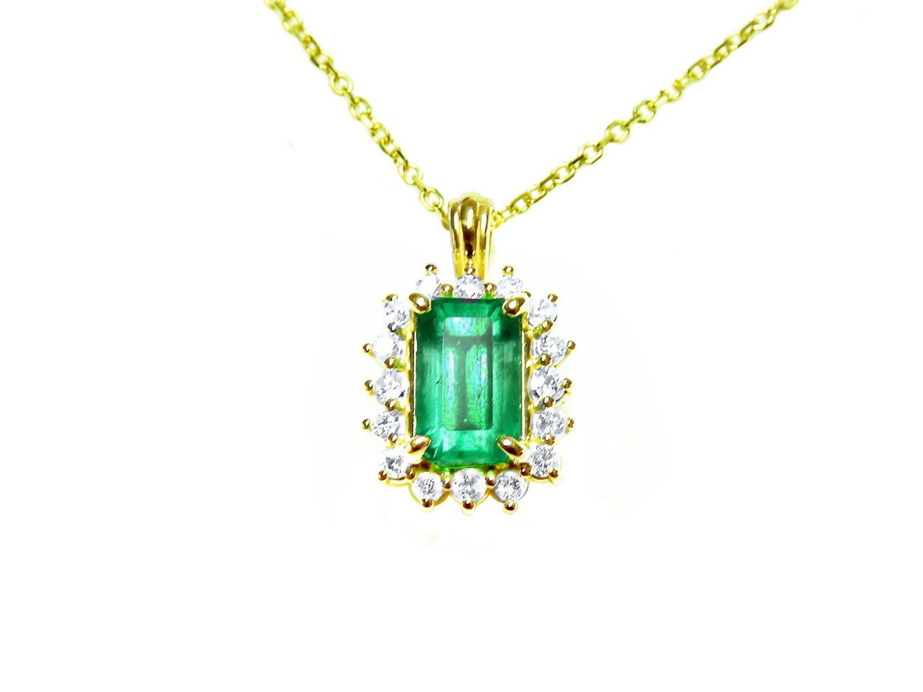 Gold necklace with a rectangular natural colombian emerald with halo diamond pendant on a topside position view.