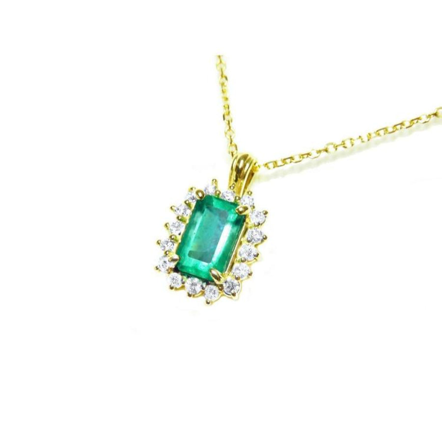 14K yellow gold pendant with a rectangular emerald surrounded by a halo of natural diamonds.