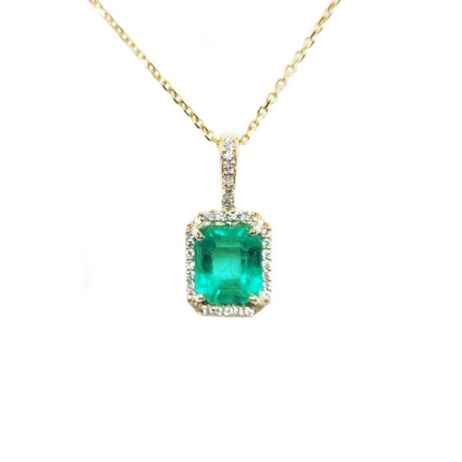 Emerald-cut emerald pendant with diamond halo on a 14k yellow gold chain.