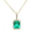 Emerald-cut emerald pendant with diamond halo on a 14k yellow gold chain.