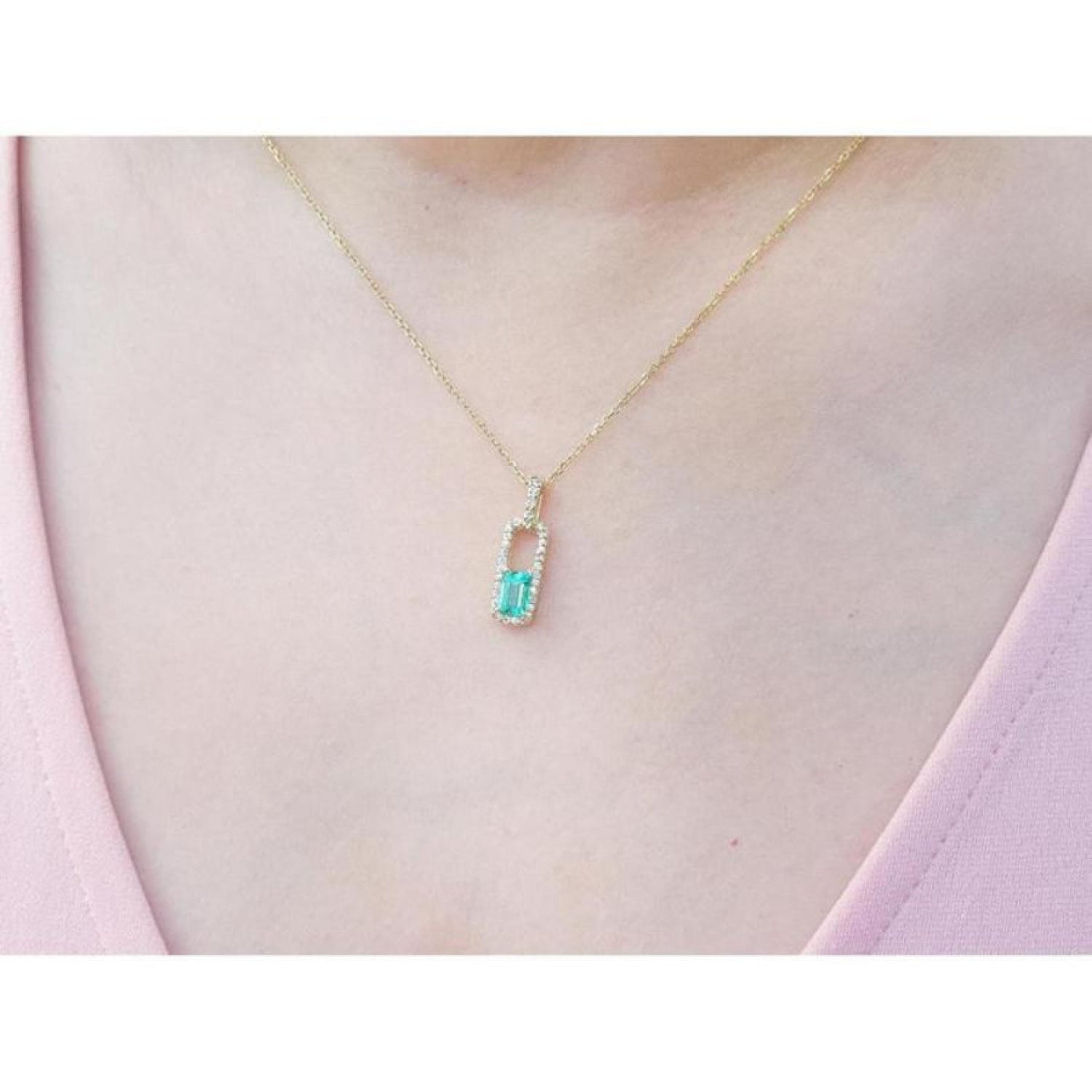 18K yellow gold emerald-cut emerald pendant with diamond halo on a delicate chain.