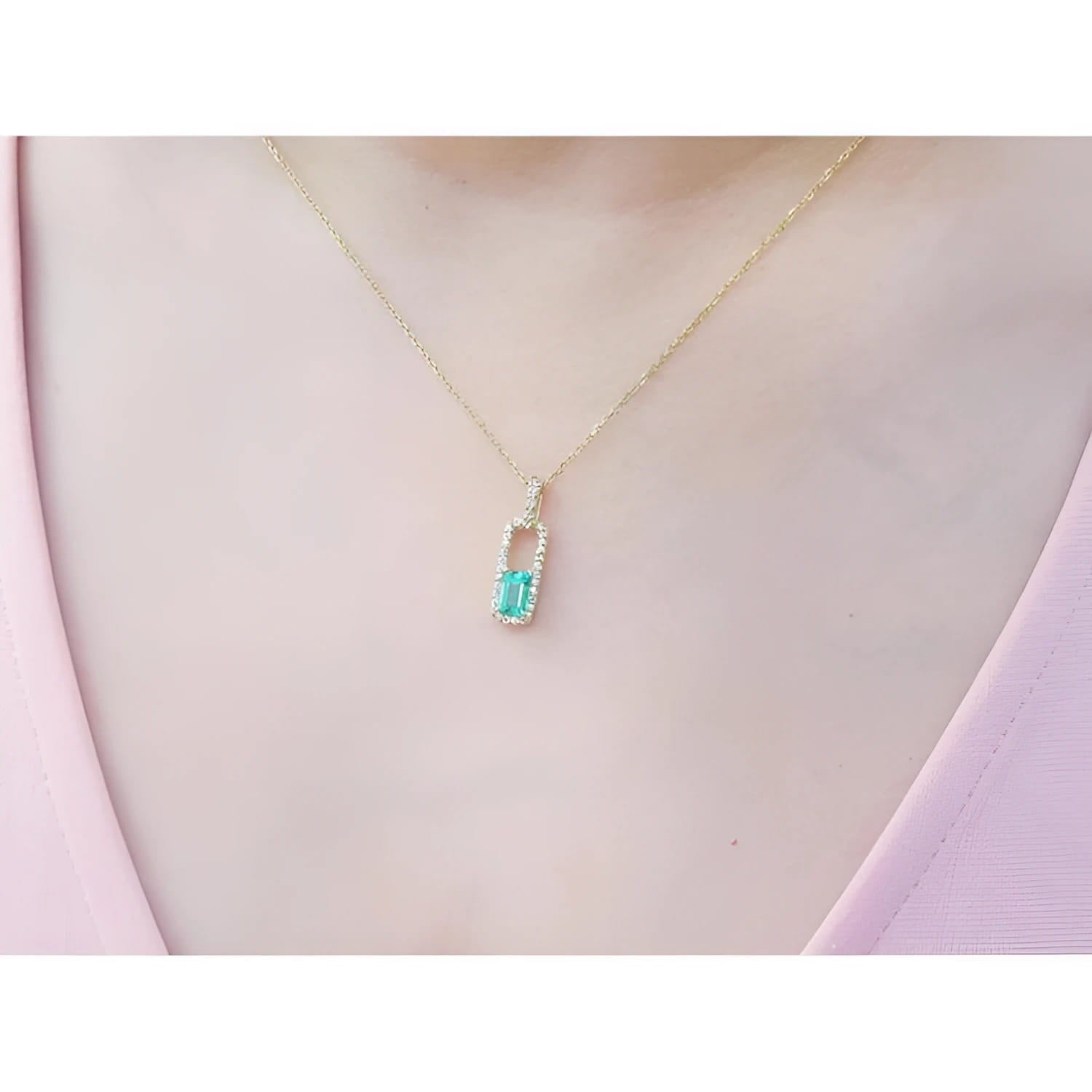 18K yellow gold emerald-cut emerald pendant with diamond halo on a delicate chain.