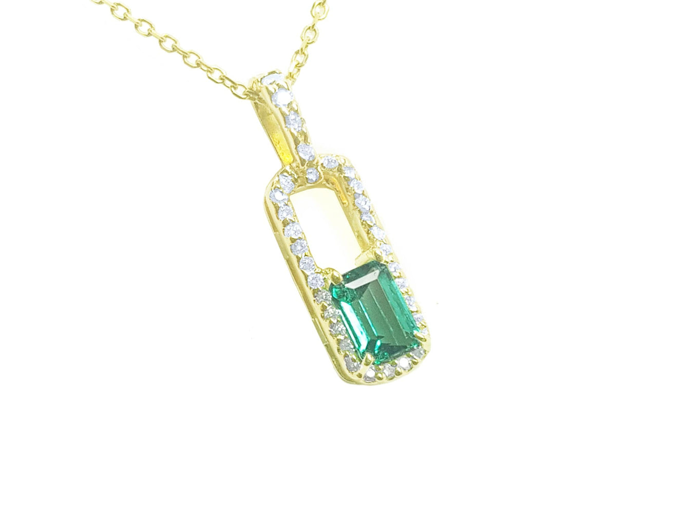 Gold necklace with a natural emerald-cut emerald pendant with a halo diamond, top and side profile visibles.