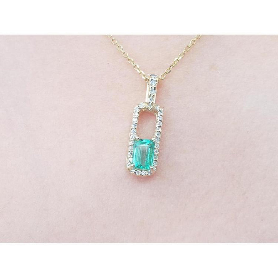 18K yellow gold emerald-cut emerald pendant with diamond halo on a delicate chain.