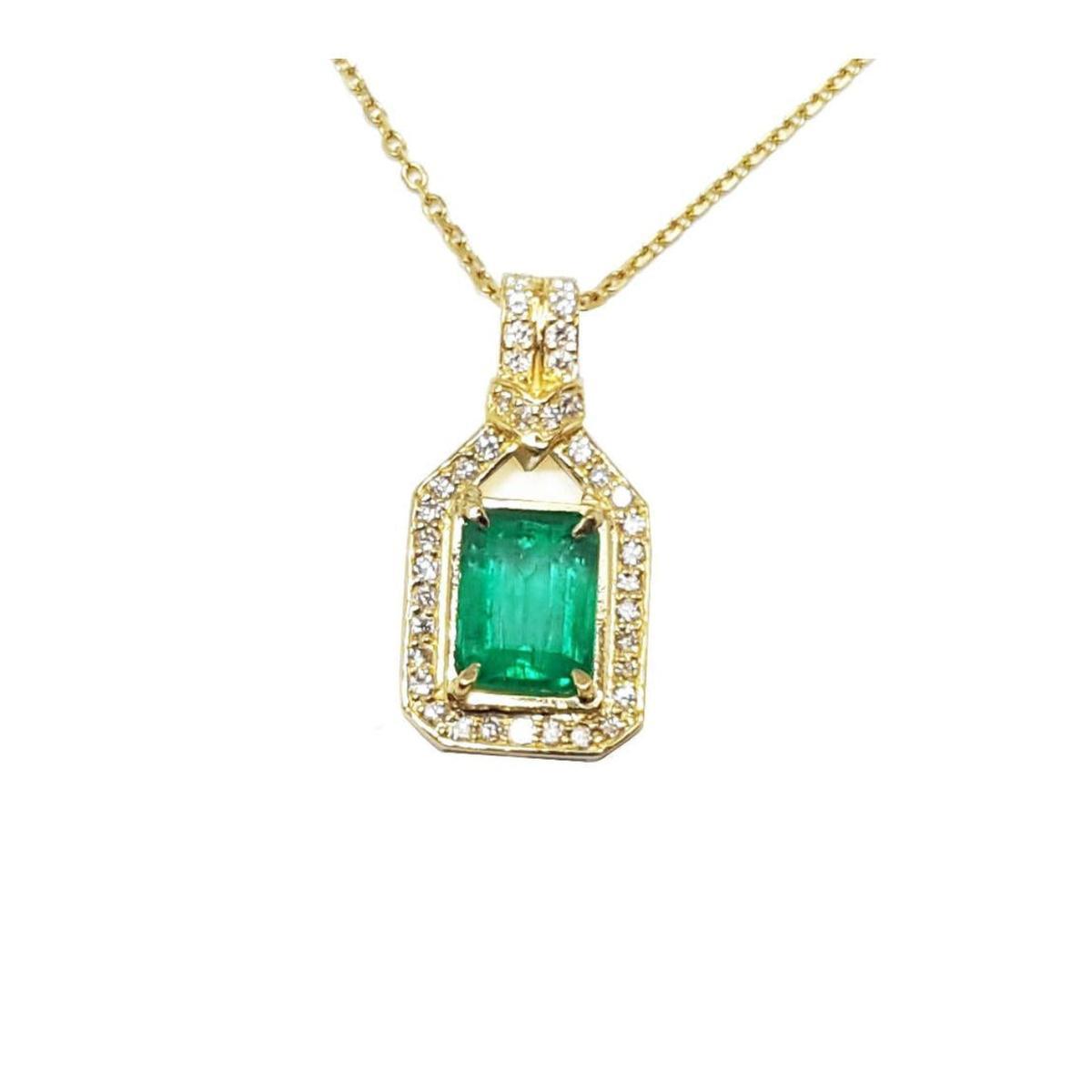 A 18k yellow gold natural emerald pendant, the square center gemstone is surrounded by natural diamonds, topside view.