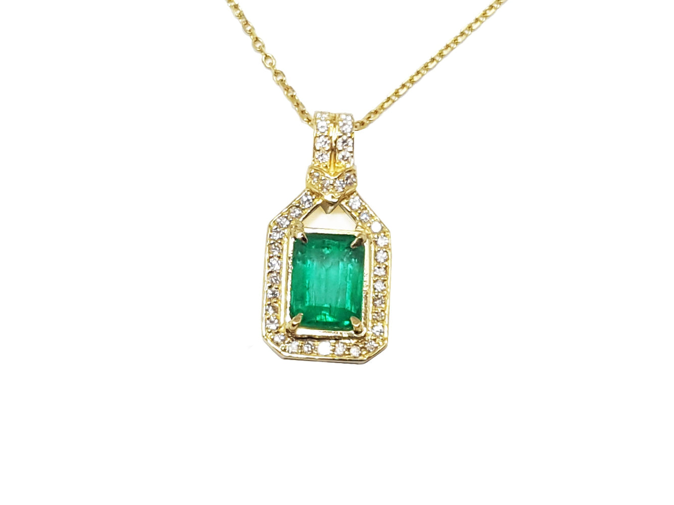 A 18k yellow gold natural emerald pendant, the square center gemstone is surrounded by natural diamonds, topside view.