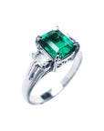 This emerald platinum ring for ladies is displaying the right-side profile.