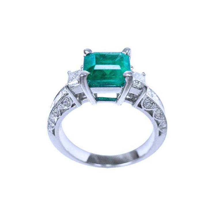 1.62 ct. square emerald ring with side princess cut diamonds on a 14K white gold band.