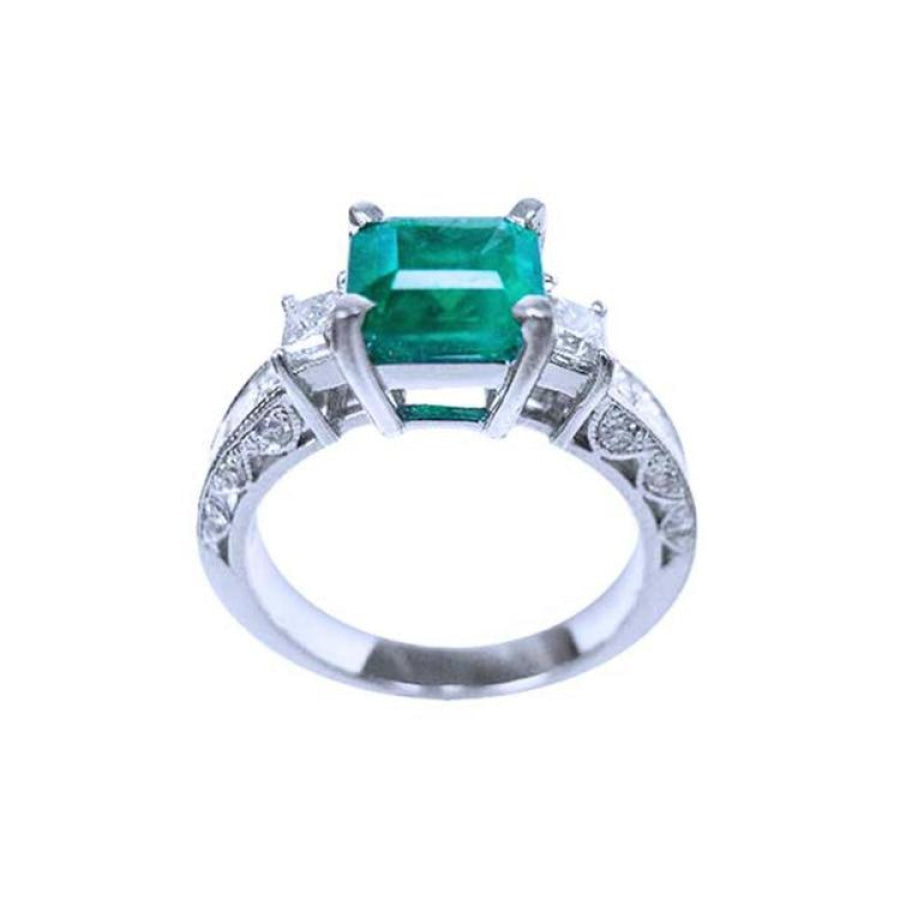 1.62 ct. square emerald ring with side princess cut diamonds on a 14K white gold band.